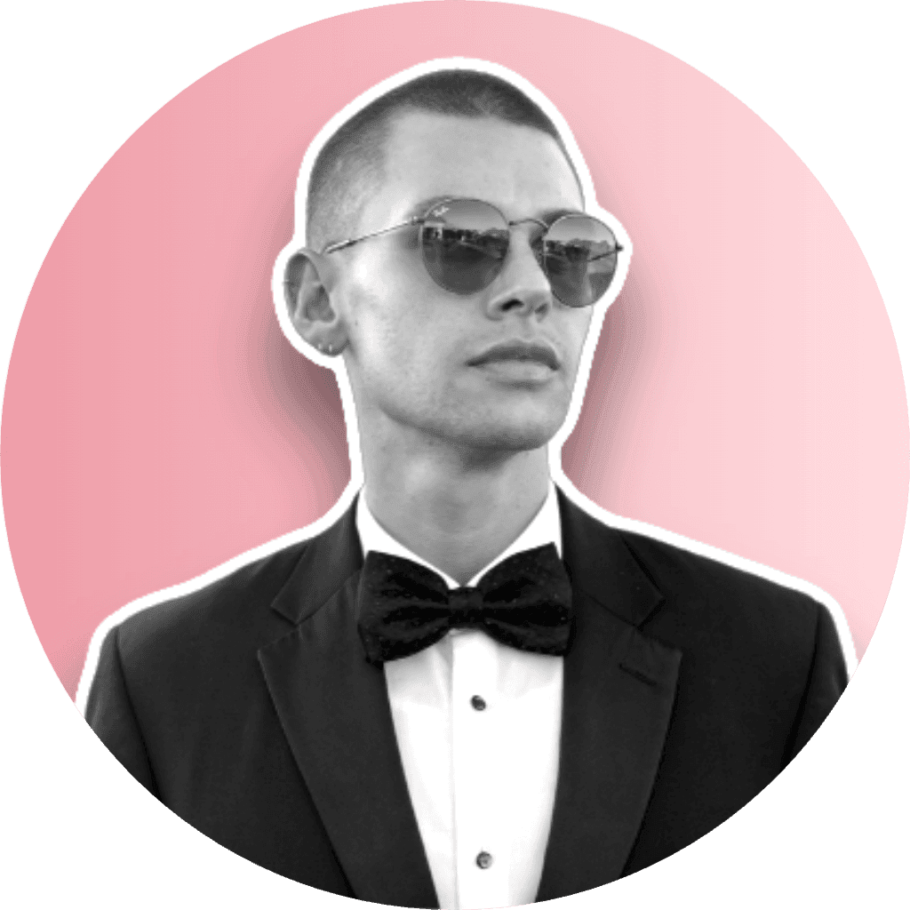 Person in a tuxedo with bow tie and sunglasses, set against a pink background.